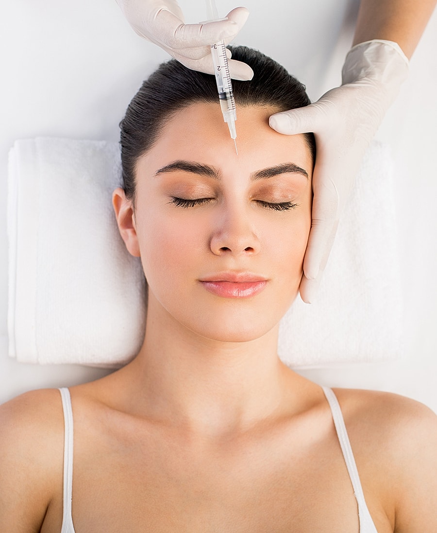 Woman receiving cosmetic treatment in a clinic.