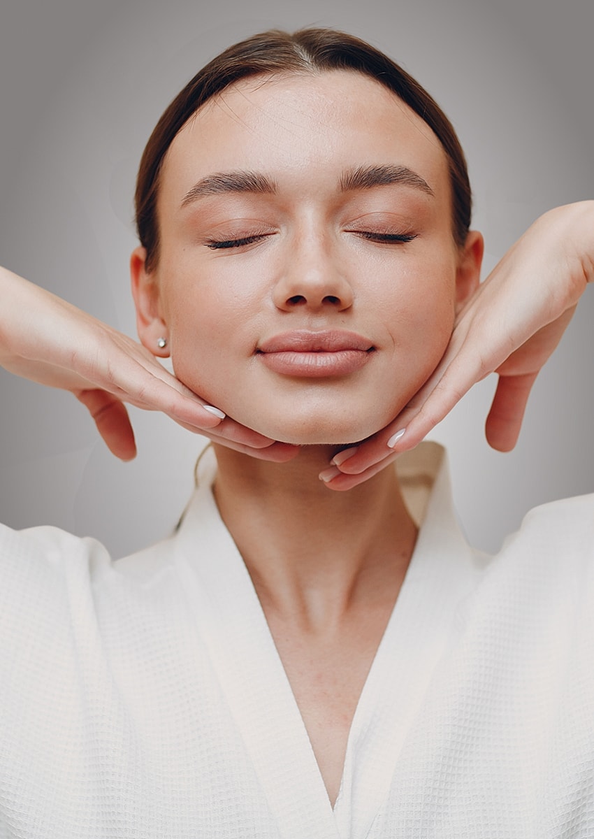 Woman relaxing with hands on her face.