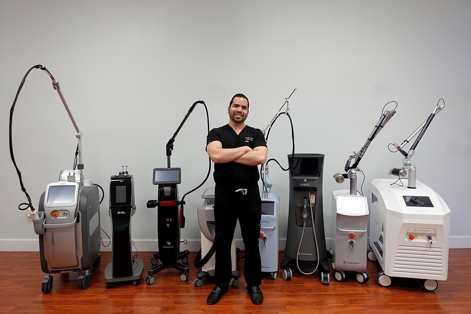 Laser technician posing with laser machines.
